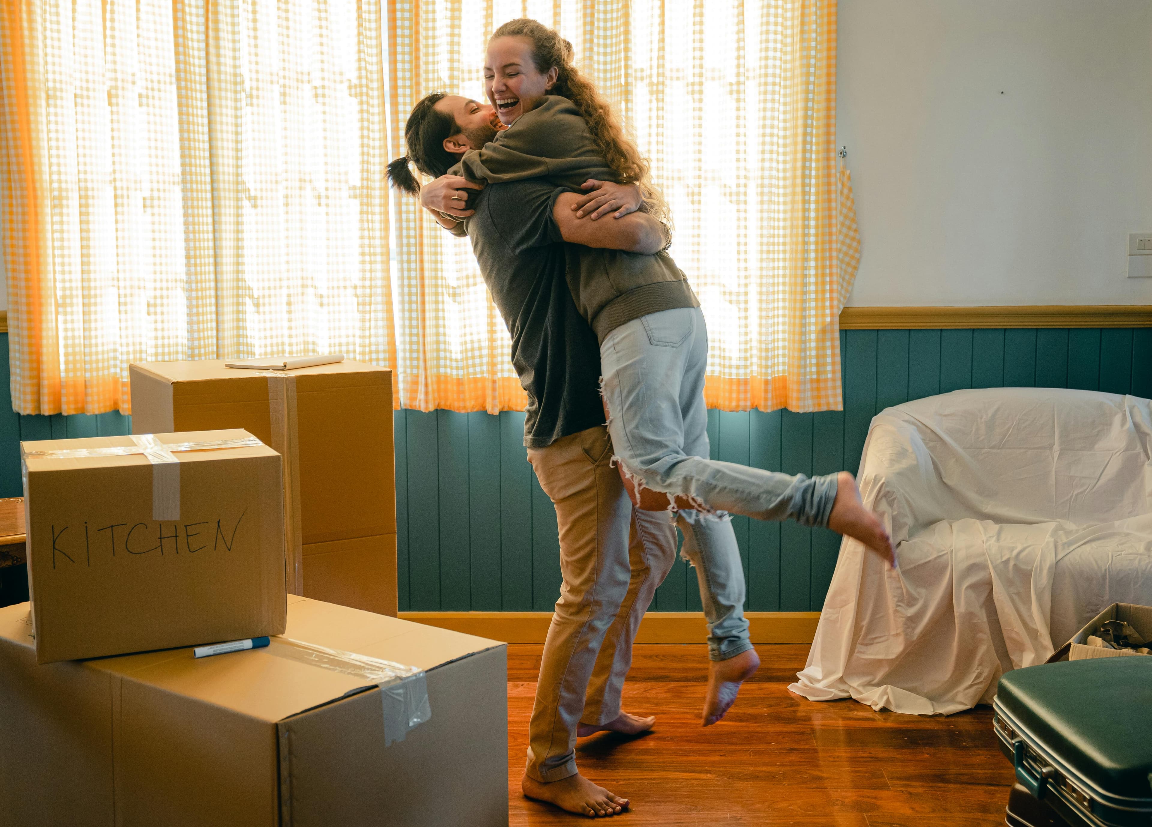 Happy couple embracing in their new home